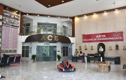 College lobby with a large ACE sign, beige patterned wall, and a reception area; a small red and black toy car sits on the marble floor in the foreground.